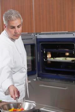 Chef Cooking Vegetables In Work Pan Stock Photos