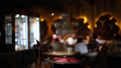 Chef cooks beef steak, sprinkling with salt on a background of restaurant. Stock Footage 344744606