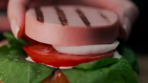 Chef cooks a burger, making of a burger, sausages and buns, fast food cooking Stock Footage 94104076