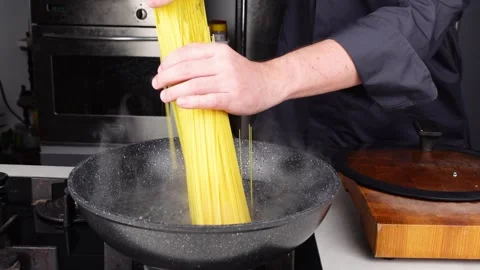 Chef cooks making Italian Capellini spaghetti pasta Stock Footage 260235053