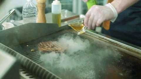 Chef cooks meat on fire. 4k Stock Footage 76429958