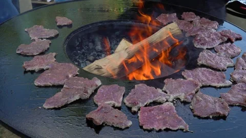 The chef cooks meat on a grill Stock Footage 247714424