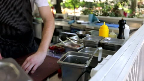 The chef cooks in the open area Stock Footage 245587892