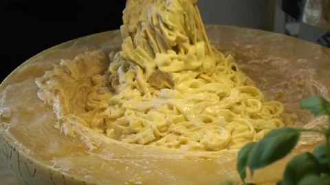 The chef cooks spaghetti in a large piece of cheese Stock Footage 257318210