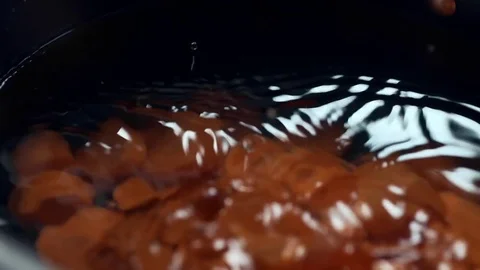 Chef cooks vegetable broth with carrot, onion and spices, slow motion cooking Stock Footage 72979310