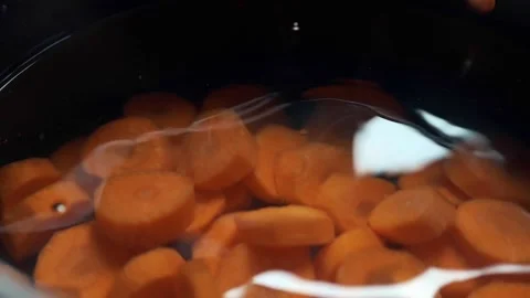Chef cooks vegetable broth with carrot onion and spices Stock Footage 143776998