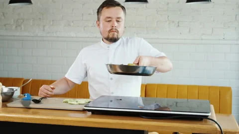 Chef cooks vegetables in pan, throwing them. Flying food frying in bowl, tossing Stock Footage 133416491