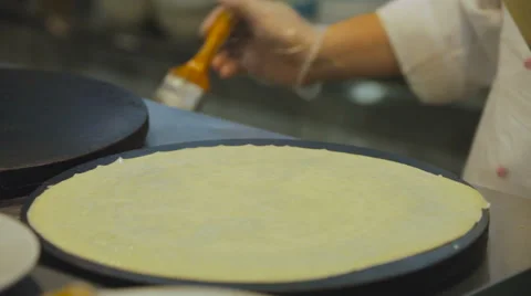Chef Corrects Pancake Edge and Preparing Pancake Brush Lubricates. Cook Stock Footage 64638618