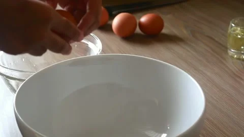 Chef cracking an egg in a bowl and separating egg white from yolk 動画素材 150586320