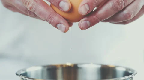 Chef cracking an egg in a bowl Stock Footage 64235776