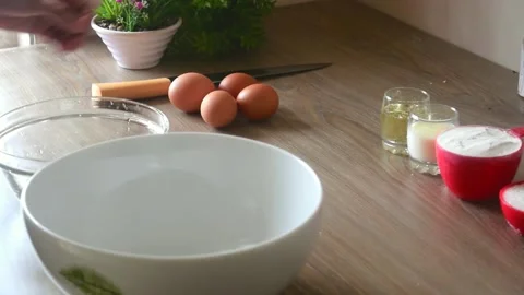 Chef cracking an egg in a bowl to separate egg white from yolk. 動画素材 150584152