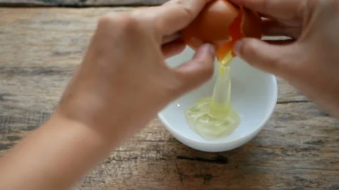 Chef cracking fresh egg in a bowl Stock Footage 135009720