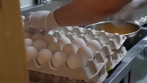 Chef Cracking Fresh Eggs in Commercial Restaurant Kitchen - Close Up Video stock 347688724