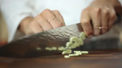 Chef crushing and cutting garlic with knife skills Stock Footage 59887726