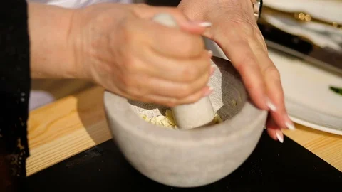 Chef crushing garlic in marble mortar Stock Footage 90465735