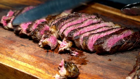 Chef cut beef on wooden Board Stock Footage 154263674