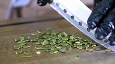 The chef cut the pumpkin seeds Stock Footage 97880970