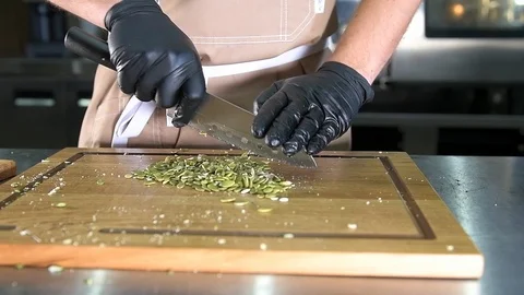 The chef cut the pumpkin seeds Stock Footage 97881030