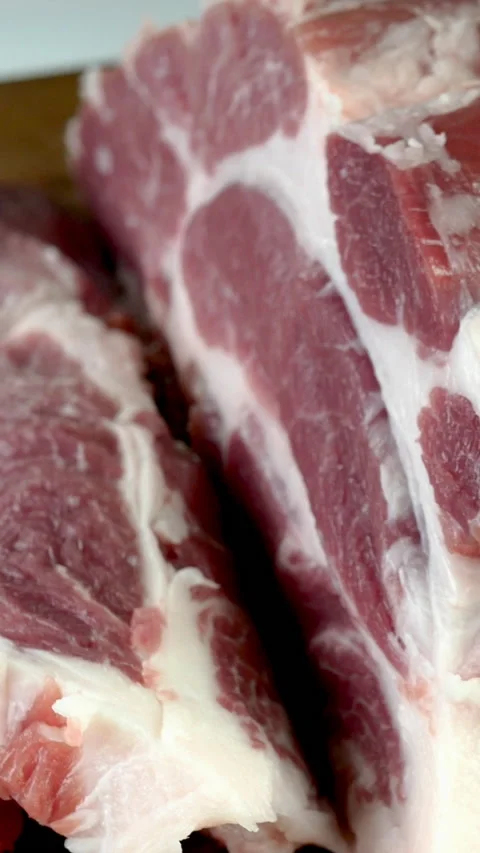 Chef cut quality raw meat with sharp knife into steak before cooking. Stock Footage 234532948