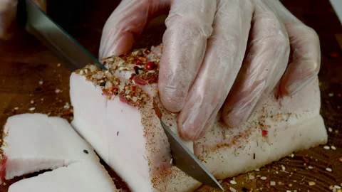 Chef cut raw pork lard on wooden kitchen board with sharp kitchen knife. Stock Footage 234069806