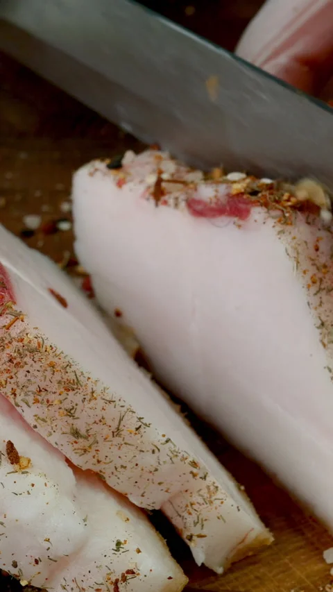 Chef cut raw pork lard on wooden kitchen board with sharp kitchen knife. Stock Footage 234533326