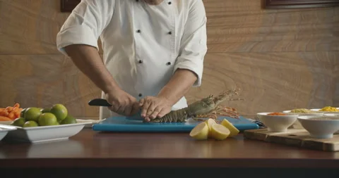 Chef cut up sharp knife large lobster. 4K slow motion video Stock Footage 103843387