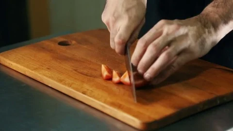 Chef cut the tomatoes on a cutting board Stock Footage 70528595