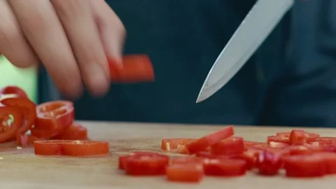 Chef cuts and peels red peppers close up of hands and knife full HD video Stock Footage 130776246