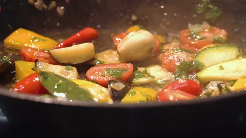 The chef cuts and roasts vegetables in a frying pan Stock Footage 158020503