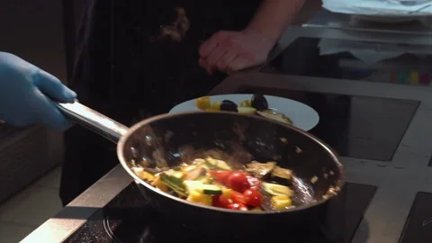 The chef cuts and roasts vegetables in a frying pan Stock Footage 158020513