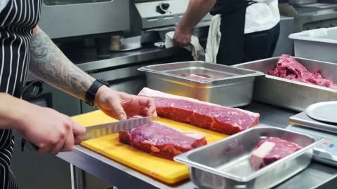 Chef cuts and weights meat  Stock Footage 201895040