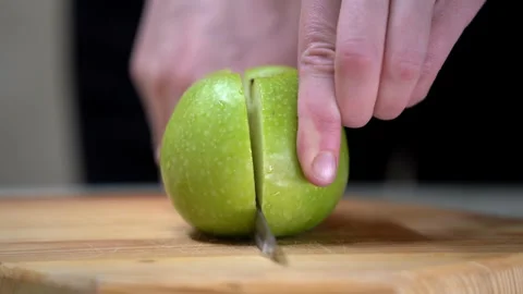 Chef cuts apples with knife on a cutting board to make dessert compote or fruit Stock Footage 270061270