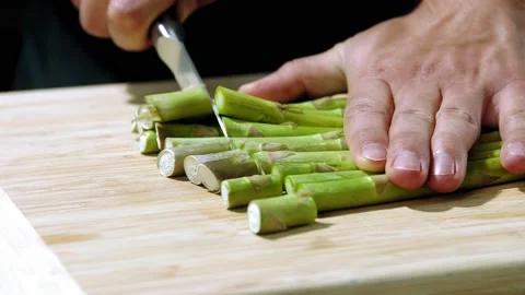 Chef cuts the asparagus slow motion Video stock 146750563