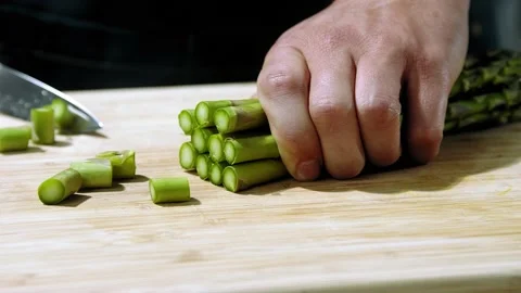 Chef cuts the asparagus slow motion Stock Footage 153766908
