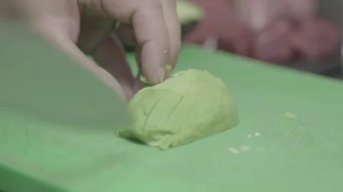 Chef cuts avocado with knife on cutting board 動画素材 132464883