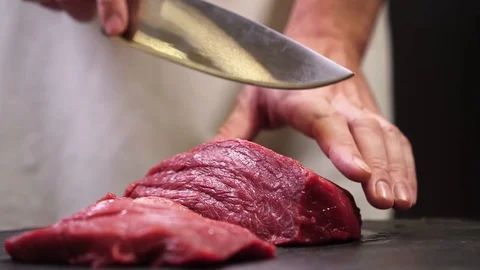 Chef cuts beef for steak. slow motion Stock Footage 121741305