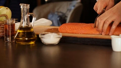 The chef cuts a big piece of raw salmon fillet.High protein foods Stock Footage 116675089