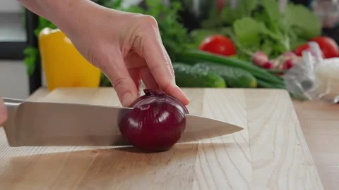 Chef cuts blue onions with a sharp knife on a wooden board Stock Footage 270151016