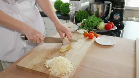 The chef cuts the boiled chicken breast into slices Stock Footage 270146238