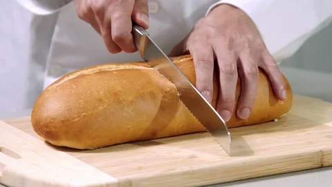 Chef cuts the bread slow motion Video stock 219809908