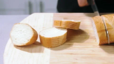 Chef cuts the bread slow motion Stock Footage 220280553