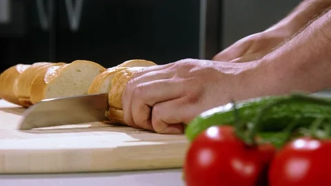 Chef cuts the bread slow motion Stock Footage 221850190
