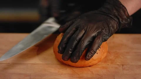 The chef cuts a bun in the kitchen. Close up Stock Footage 131152114