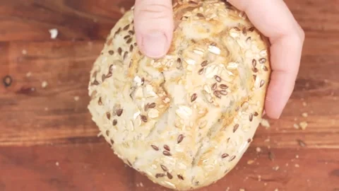 Chef cuts buns in half to prepare burgers or sandwich. Slicing fresh bread .. Stock Footage 303977252