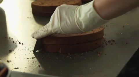 The chef cuts the cake for the cake into equal parts Stock Footage 68386541