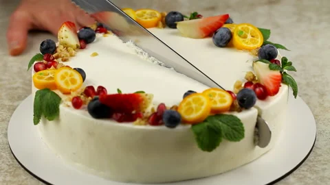 The chef cuts a cake decorated with fresh fruit. Slicing a pie close-up Stock Footage 195321435