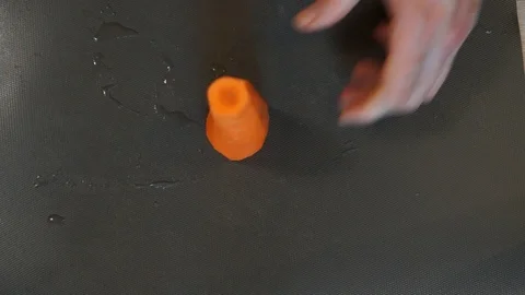 Chef cuts carrot. Cooking process. Hands cutting carrot. Chef slices the carrot Stock Footage 100105834
