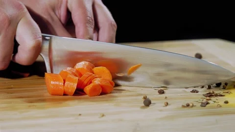 Chef cuts the carrot slow motion 스톡 동영상 219809813