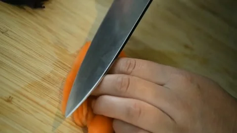 Chef cuts carrots for salad with a sharp knife. Stock Footage 151663120
