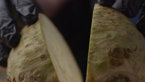 Chef cuts celery root into two parts 스톡 동영상 121703000